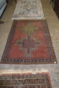 20TH CENTURY WOOL FLOOR RUG DECORATED WITH LARGE CENTRAL PANEL SURROUNDED BY A THREE TIER BORDER