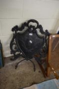 LATE VICTORIAN COPPER AND IRON FIRE SCREEN OF SHIELD AND FOLIATE FORM WITH EASEL BACK