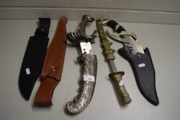MIXED LOT COMPRISING THREE VARIOUS MODERN STAINLESS STEEL KNIVES OF ELABORATE FORM, PLUS TWO FURTHER
