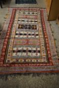 20TH CENTURY MIDDLE EASTERN WOOL FLOOR RUG DECORATED WITH A LARGE CENTRAL PANEL SURROUNDED BY A