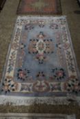 MODERN CHINESE WOOL FLOOR RUG DECORATED WITH FLOWERS ON A PALE BLUE BACKGROUND, 190CM WIDE
