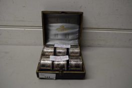 CASED SET OF SIX SILVER PLATED NAPKIN RINGS, THE CASE MARKED ‘CAMERON & SON, KILMARNOCK’