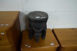 ETHNIC HARDWOOD STOOL FORMED AS A STYLISED ELEPHANT, CARVED FROM A SINGLE PIECE OF WOOD, 32CM HIGH