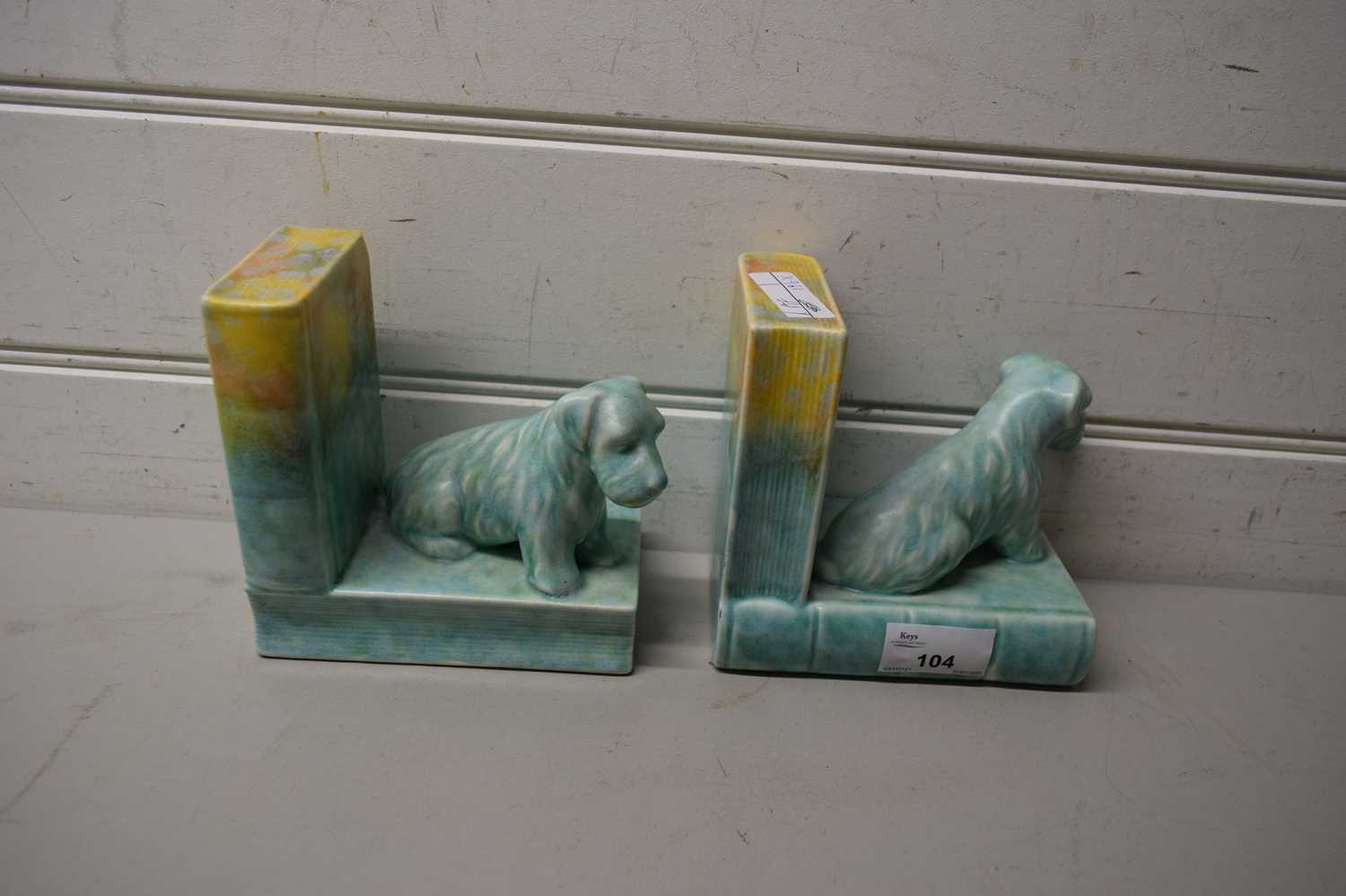 PAIR OF EARLY 20TH CENTURY CERAMIC BOOK ENDS FORMED AS DOGS (A/F)