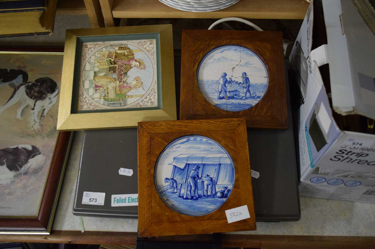 TWO DELFT BLUE AND WHITE TILES SET IN OAK FRAMES PLUS ONE OTHER (3)