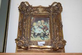 REPRODUCTION VIENNA PORCELAIN TILE DECORATED WITH AN OLD MAN AND CHILDREN, SET INTO A HEAVY GILT