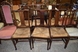 SET OF FOUR LATE 19TH/EARLY 20TH CENTURY RUSH SEATED MAHOGANY FRAMED DINING CHAIRS WITH TAPERING