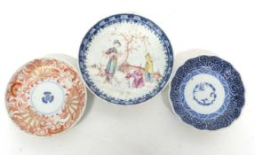 Group of three Chinese porcelain saucers, 18th/19th century, one with polychrome design of figures