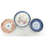 Group of three Chinese porcelain saucers, 18th/19th century, one with polychrome design of figures