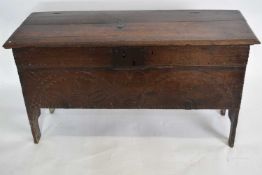 18th century and later oak coffer, plain board top over a body with carved front raised on simple