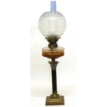 Late 19th century oil lamp with Corinthian column and amber glass reservoir with white engraved