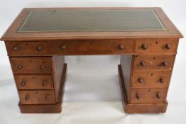 Victorian mahogany twin pedestal desk fitted with nine drawers and a green tooled leather writing