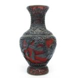 Oriental vase, the cinnabar type ground with carved wooden decoration, 17cm high