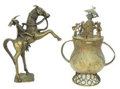 Two Ashanti metal wares including a warrior on horseback, together with a further melting pot, the