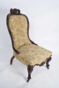 Victorian mahogany framed nursing chair with arched back over a seat supported on front cabriole