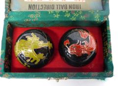 Boxed set of iron dragon balls with gilt decoration