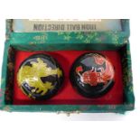 Boxed set of iron dragon balls with gilt decoration