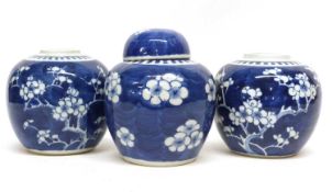 Group of three Chinese porcelain ginger jars, one with matching cover, all decorated with prunus