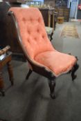 Victorian mahogany framed nursing chair raised on short scrolled legs and upholstered in buttoned