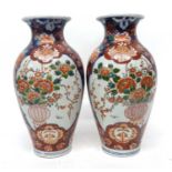 Pair of Japanese porcelain vases with Imari design and central cartouche of flowers in a vase,