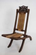 Late 19th/early 20th century Far Eastern folding chair with cane work seat and back, 81cm high