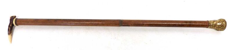 Novelty riding crop with bone tooth to one end, the crop unscrews at the middle to reveal a dip