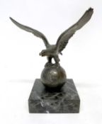 Metal model of a globe with eagle with outstretched wings, on square shaped onyx base