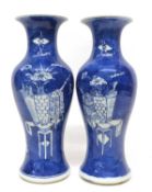 Two 19th century Chinese porcelain vases, the blue ground decorated with precious objects, 25cm high