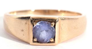 Modern 9ct gold and tanzanite ring, the round shaped tanzanite box set and raised in a plain
