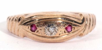 9ct gold diamond and ruby boat shaped ring centring a small single diamond flanked by two small