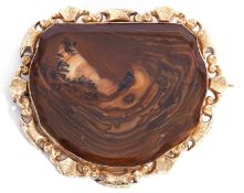 Large agate brooch, the brown agate panel with bevel cut edges, framed in an ornate metal shield and