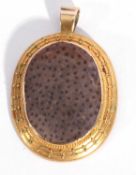 Antique yellow metal hardstone set pendant of oval form, the stone centre 3 x 2cm in cut down
