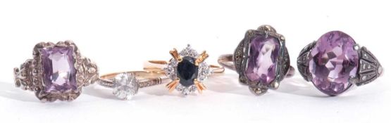 Mixed Lot: three white metal and purple stone set rings, a single white stone ring stamped 'silver',