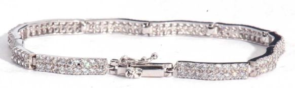 Modern articulated line bracelet set with small white stones and stamped 9k, 20cm long