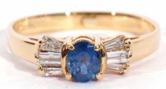Modern 18ct gold sapphire and diamond ring, the oval faceted sapphire four-claw set and raised