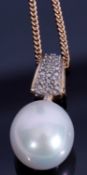 Modern cultured pearl drop pendant supported from a 9ct gold diamond encrusted bale, suspended on
