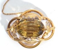 Antique gold and citrine brooch, the tubular and leaf decorated frame centring a large faceted lemon