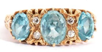 Aquamarine and diamond ring featuring three graduated oval shaped aquamarines, highlighted between