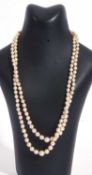 Double row of graduated cultured pearls, 4-8mm, joined by a diamond and sapphire Art Deco clasp,