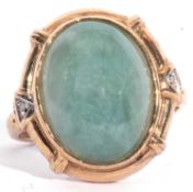 Modern 9ct gold green hardstone ring, the cabochon stone framed in a small twin diamond