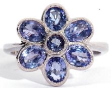 18ct white gold and tanzanite cluster ring, a flowerhead design with a raised round cut tanzanite