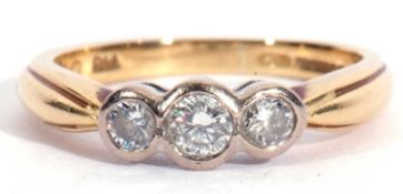 18ct gold three stone diamond ring featuring three round graduated brilliant cut diamonds, each in