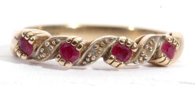 Modern 9ct gold ruby an diamond ring, a Celtic design featuring four small rubies highlighted