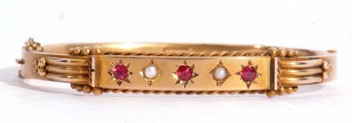 Antique ruby and seed pearl hollow hinge bracelet, the top section with three round cut rubies and