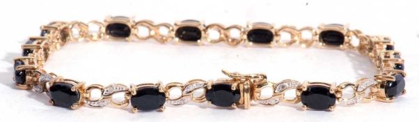 Modern 9ct gold sapphire and diamond line bracelet featuring 14 oval cut dark sapphires joined by