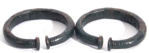 Pair of bronzed metal torc bracelets with green patinated finish