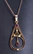 Vintage gilt metal open work oval shaped pendant centring a purple stone dropper, further
