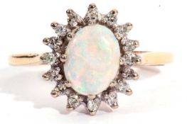 18ct gold opal and diamond cluster ring, the cabochon opal measures 9mm x 6mm set within a small