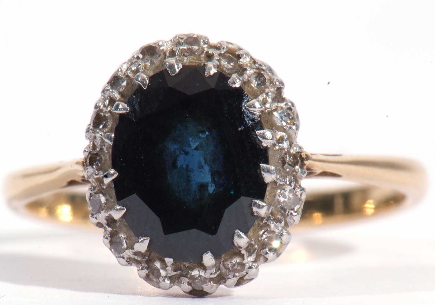 Sapphire and diamond cluster ring, the oval faceted dark sapphire 9.26mm x 7.52mm x 3.24mm, within a - Image 2 of 6