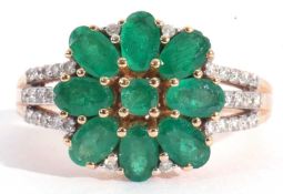 Modern 18ct gold emerald and diamond cluster ring, the centre with an emerald flowerhead design